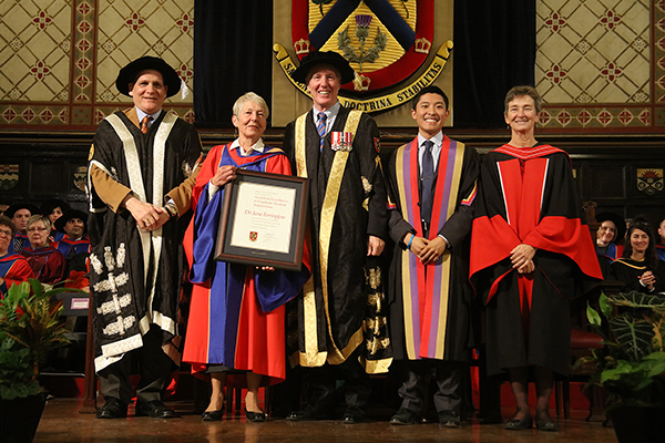 Jane Errington (History), second from left, receives the Graduate Supervision Award during Fall Convocation. From left are: Principal Daniel Woolf; Chancellor Jim Leech; Rector Cam Yung; and Brenda Brouwer. Vice Provost and Dean of the School of Graduate Studies. (Photo by Bernard Clark)