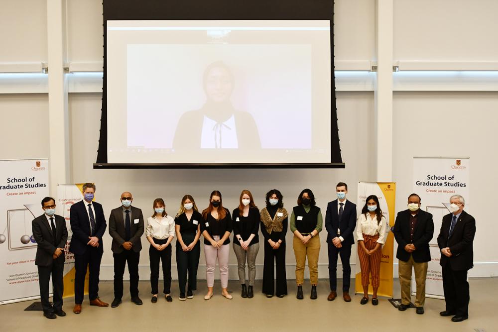 Participants and judges gather at the end of the Queen’s Three Minute Thesis competition at Mitchell Hall. The winning presentation was delivered by Amtul Haq Ayesha, who participated remotely. (Queen's University)