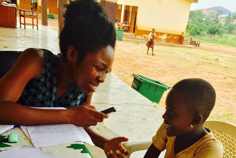 [Photo of Christiana Asantewaa Okyere with a student]
