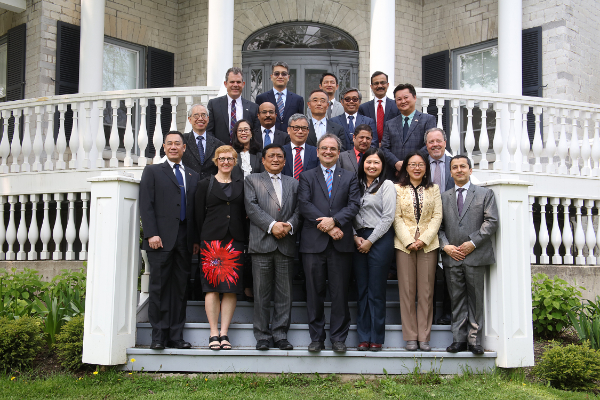 Queen’s representatives and international ambassadors pose together in front of Summerhill, a yearly tradition after the Ambassadors’ Forum.