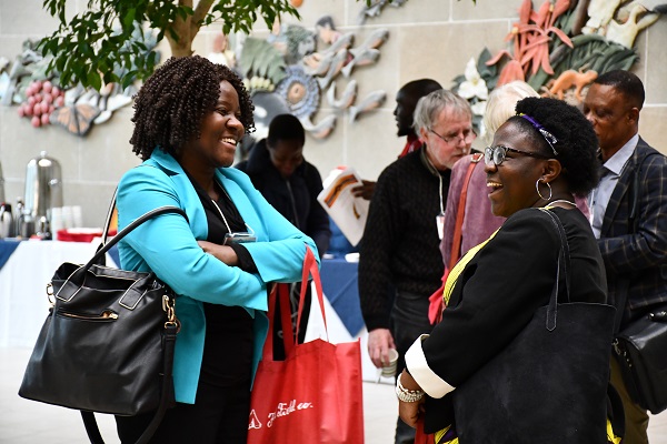 [Conference attendees share a laugh during the conference. (Photo: Faculty of Arts and Science)]