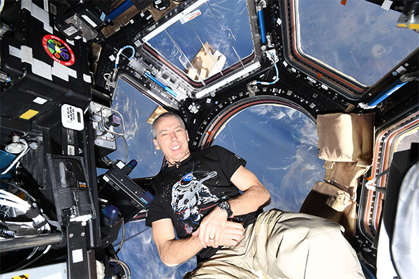 Astronaut and alumnus Andrew Feustel (PhD’95) poses above the Earth. (Photo: @Andrew_Feustel on Twitter)