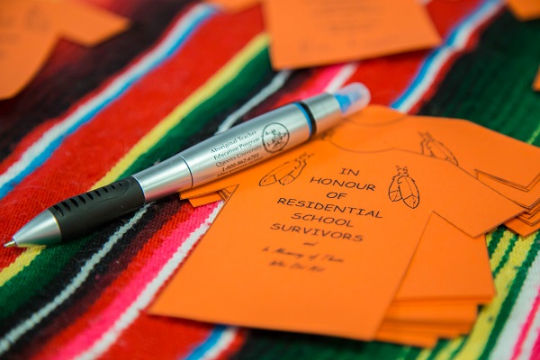 An orange shirt made of paper, similar to the one that was taken from Phyllis Webstad, which the ATEP students made to mark Orange Shirt Day. (Supplied Photo)