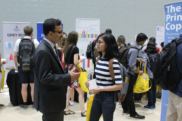 Fahim Quadir speaking to a student.