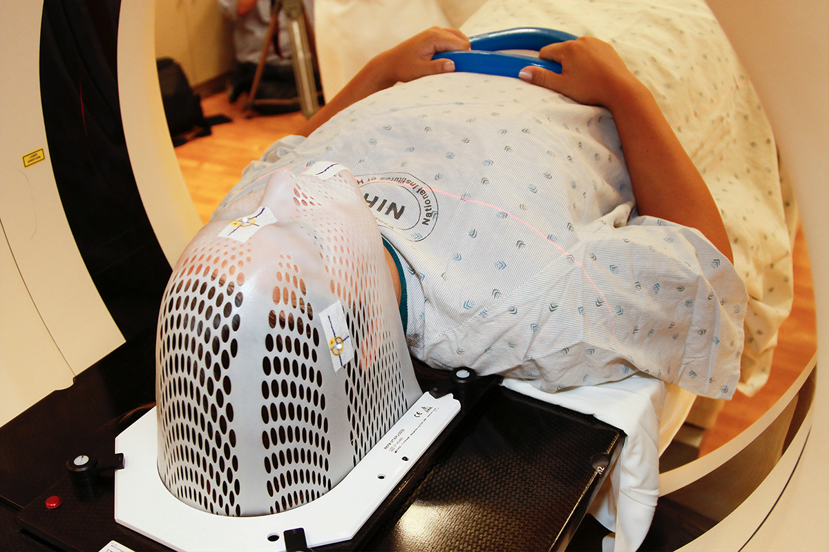 A woman enters an MRI machine for a brain scan.