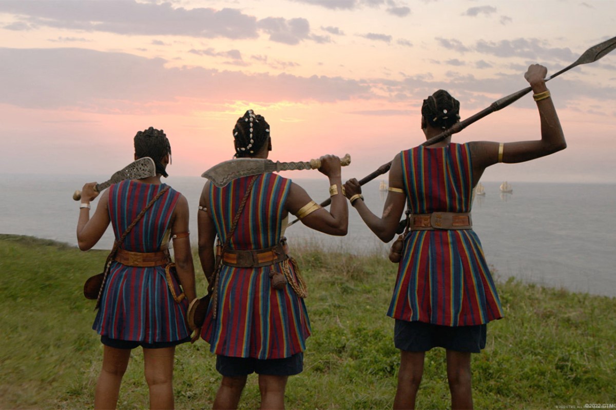 A scene from the new movie Woman King, with three female warriors overlooking the ocean.