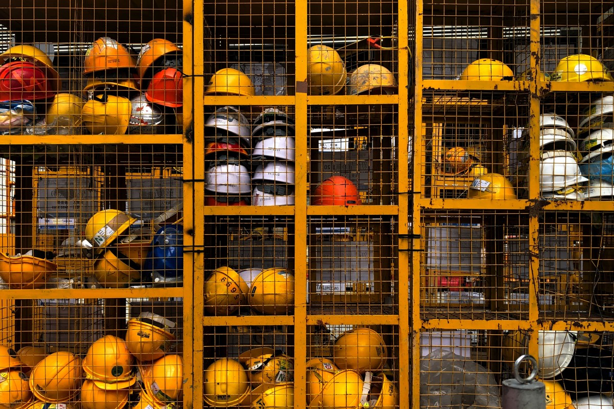 Workers helmets stored in a cage