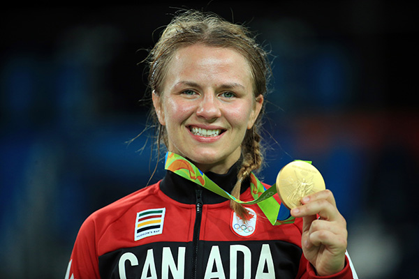 Erica Wiebe holds up a gold medal