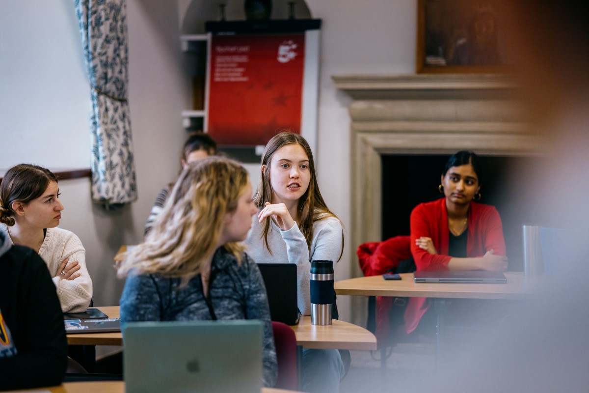 Students at desks participate in a class