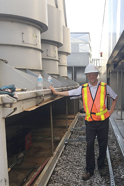 Nathan Splinter stands atop Chernoff Hall 