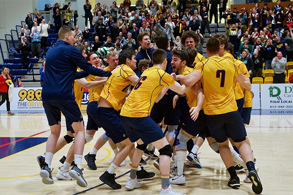 [Queen's Gaels men's volleyball players celebrate a goal]