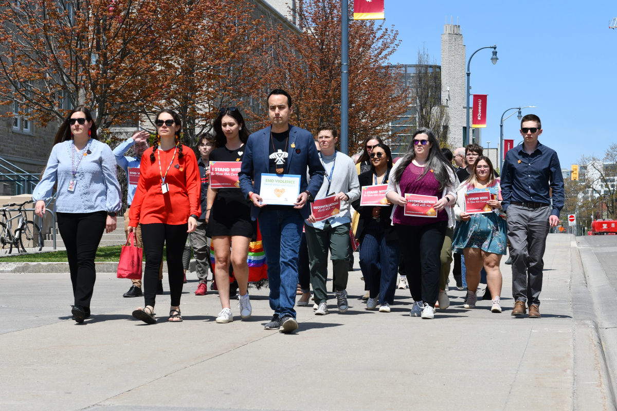 Queen's community members march together along University Avenue in support of the Moose Hide Camapign.