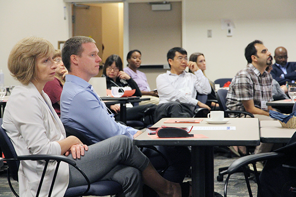 "New faculty at Queen's University listen to presentation during their orientation"