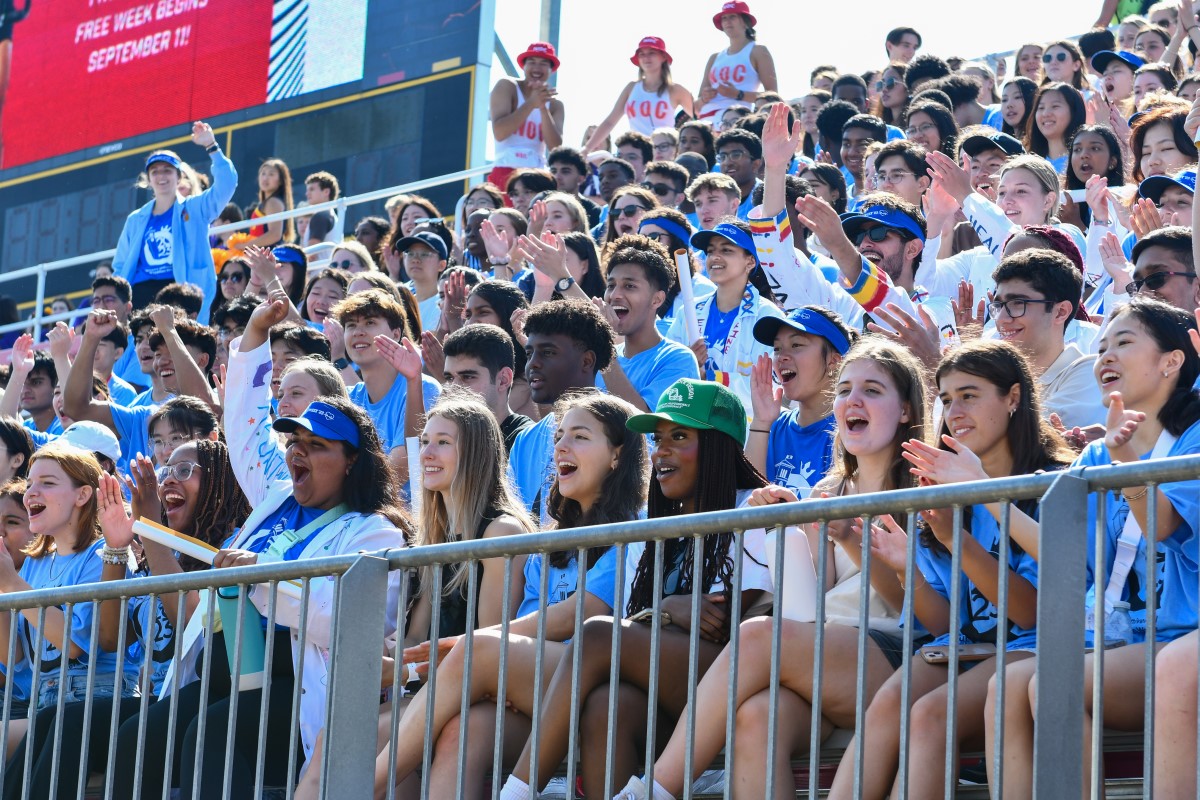 Photograph of first-year students cheering at Richardson Stadium during orientation.