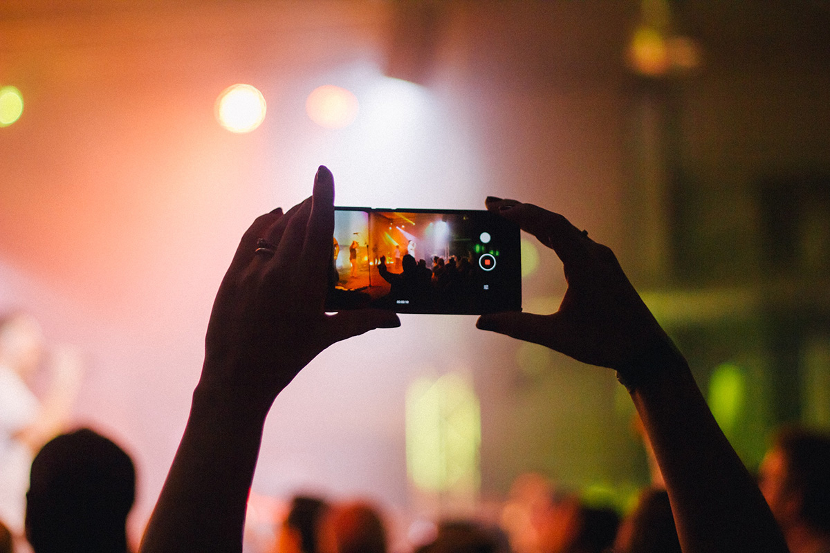 A man records a Concert with his phone