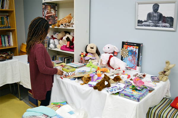 The daughter of a Queen’s student pick out donated presents for the holiday season ( Candice Pinto Photo)