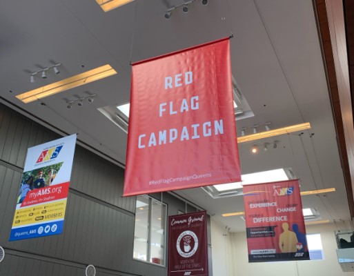 Photograph of Red Flag Campaign banner hanging in Queen's Centre.