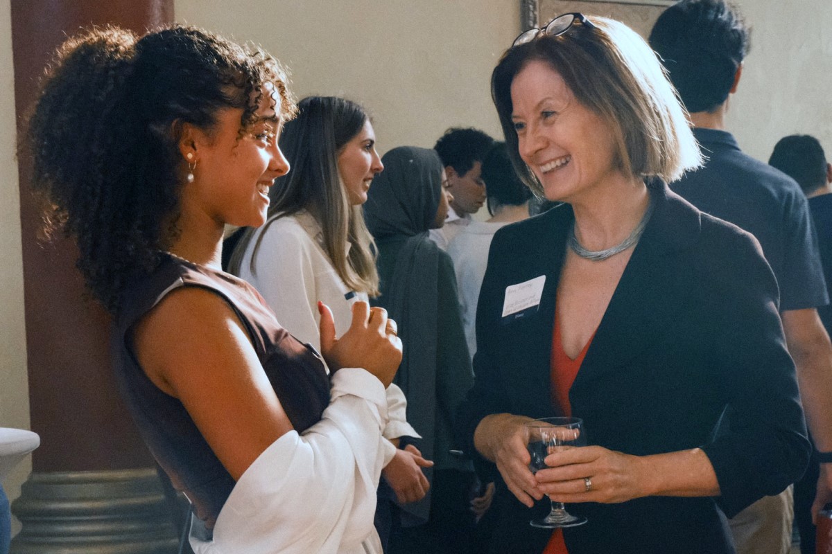 Photograph of Dean Ann Tierney speaking with a student at Grant Hall reception