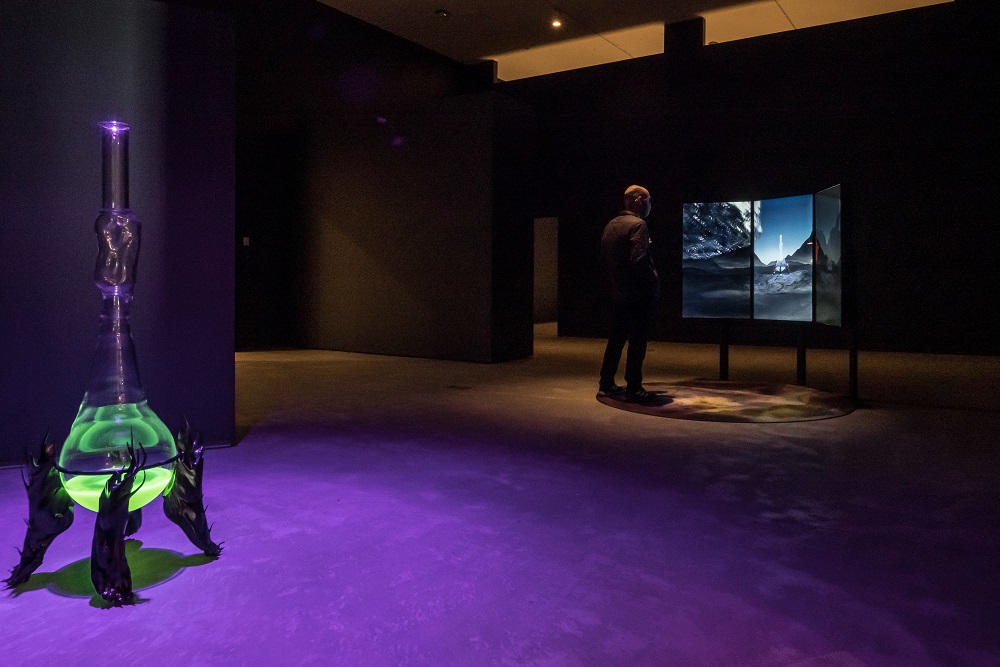 Josèfa Ntjam, Luciferin Drop, 2020, glass, metal, ABS filament and luminescent liquid and Myceaqua Vitae, 2020, video with sound. Collection of the artist. Installation view from Drift: Art and Dark Matter. Photo: Tim Forbes