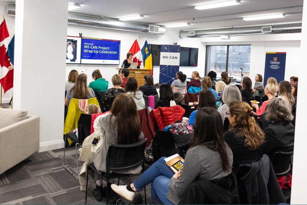 [Photo of a group of attendees at the WE-CAN Wrap-Up Event]