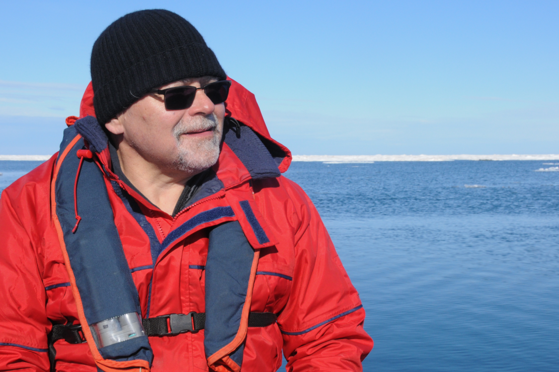 Dr. John Smol wearing a winter jacket next to water