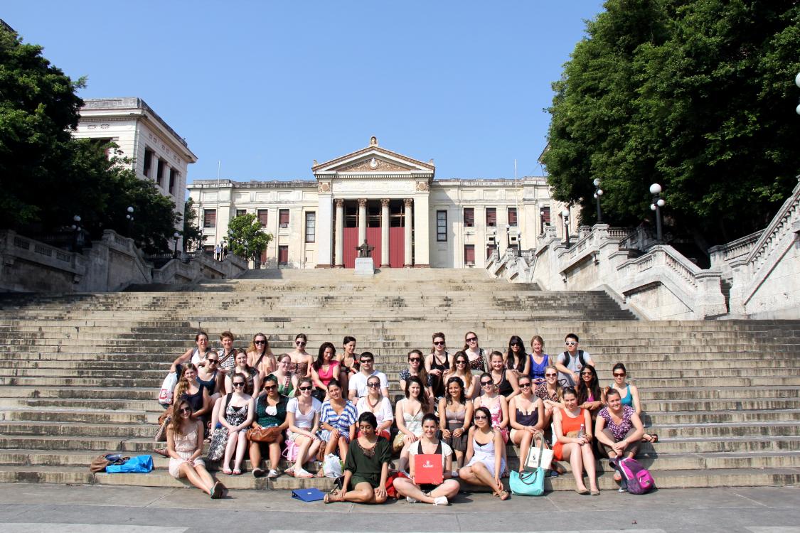 Students sitting on the steps of the University of Havana