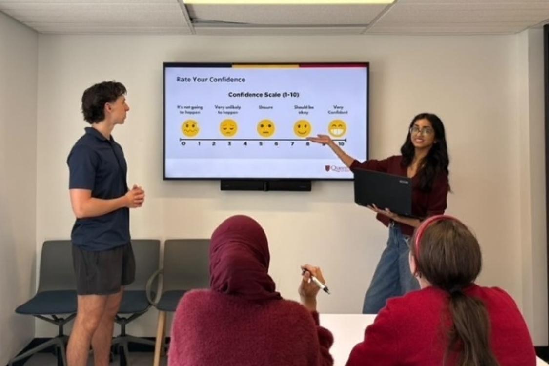 People in a group coaching session. The sessions help students build confidence, while giving volunteers leadership and facilitation experience.