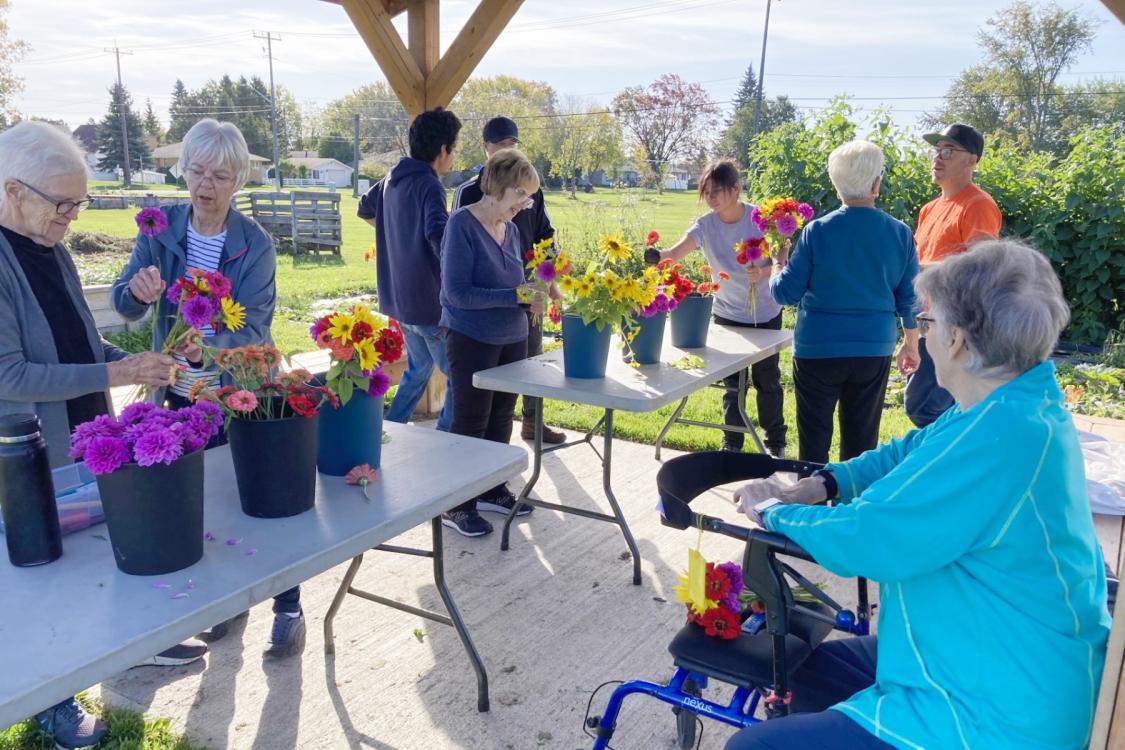 A group of people participate in a flower arranging workshop