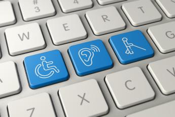 Computer keyboard including international symbols for wheelchair accessiblity, hearing impairment, and sight impairment]