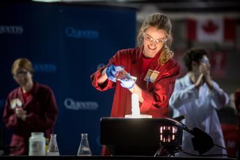 [Researcher demonstrates a chemical reaction during a Science Rendezvous performance]