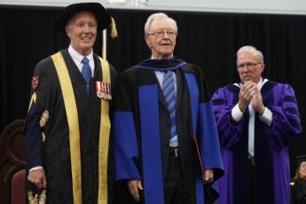 [Donald Sobey accepts honorary degree with Jim Leech and David Saunders]