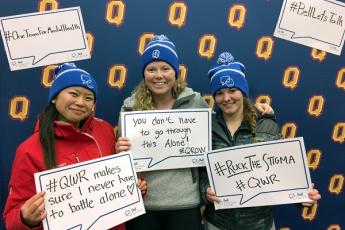 [Students with the Bell Let's Talk toques and signs]