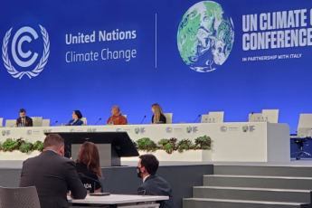 UN Climate Change Conference sign behind presenters 