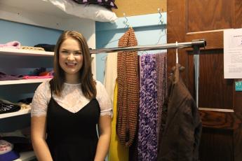 Heather Poechman, graduate student and project founder, prepares the Queen’s Winter Coat Exchange closet, surrounded by winter clothes for students in need of warming up.