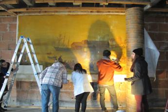 [students work on removing painting]