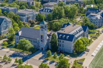 [Aerial photo of Queen's campus featuring Grant Hall]
