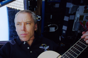 Andrew Feustel looks out over the Earth in the All Around the World music video.