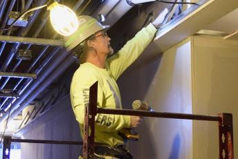 A carpenter works on construction of the Innovation and Wellness Centre. (Photo: Physical Plant Services)