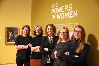 Five members of the Agnes Etherington Art Centre team, including Director Jan Allen (second from right), pose in the "Powers of Women" exhibit. (University Communications)