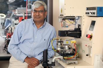 Praveen Jain standing in his lab