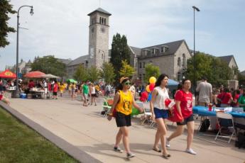 Students walk down University Avenue and take in the annual Sidewalk Sale