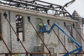 Workers are tearing out stone which has sat in these window frames since 1970. In its place will be heritage-style glass windows, which will be installed by December.
