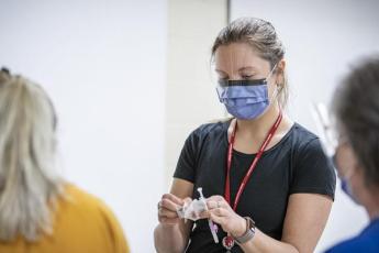 Queen's medical student Tania Yavorska prepares to vaccinate a patient