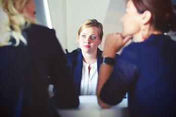 Woman CEO listens to two other women