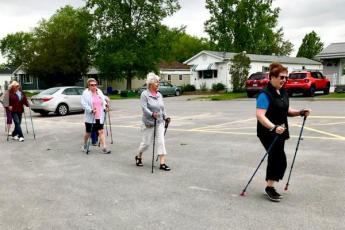 Members of the Oasis Senior Supportive Living Program pole walking in their community.