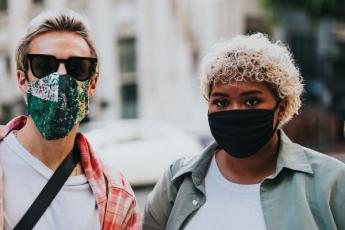A couple wears facemasks as part of COVID-19 prevention measures.