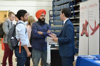 "Students speak with an exhibitor during the Career Fair at Queen's"