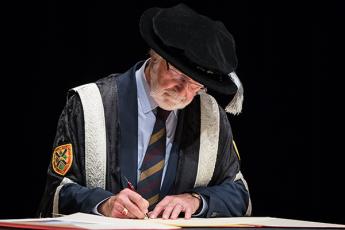 Principal Patrick Deane signs the Magna Charta Universitatum during an event hosted at McMaster University on Oct. 17, 2019.