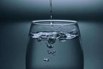 [Photo of water being poured into a glass]