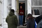 Community team talks to student at her door